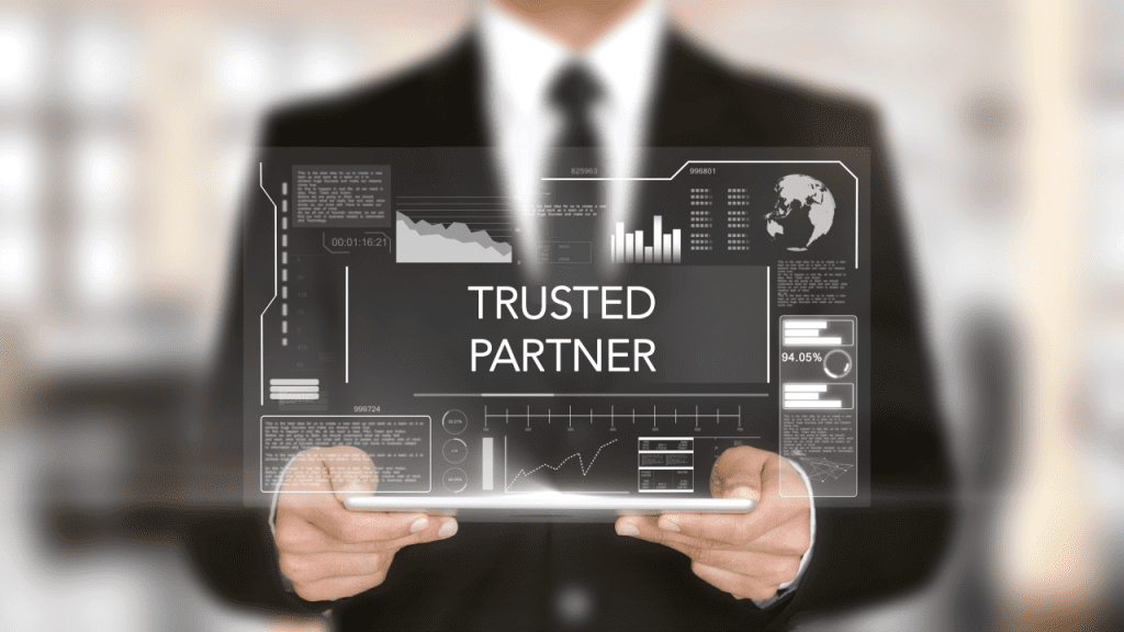 A man holding up a tablet that says trusted partner.